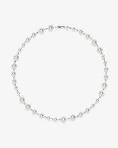 Flat lay of a handmade Swarovski crystal and pearl necklace with crystals, pearls and clean pearl styling details