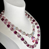 Close-up of a handmade pink Swarovski crystal charm necklace with crystals, pearls and ski-inspired collectible charm details