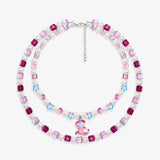 Close-up of a handmade pink Swarovski crystal charm necklace with crystals, pearls and ski-inspired collectible charm details