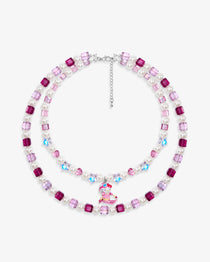 Close-up of a handmade pink Swarovski crystal charm necklace with crystals, pearls and ski-inspired collectible charm details