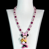 Close-up of a handmade pink Swarovski crystal charm necklace with crystals, pearls and sweetheart-inspired collectible charm details