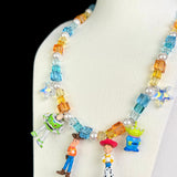 Close-up of a handmade Swarovski crystal charm necklace with crystals, pearls and rainbow-inspired collectible charm details