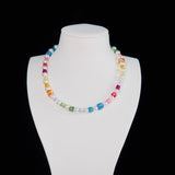 Close-up of a handmade rainbow Swarovski crystal charm necklace with crystals, pearls and rainbow-inspired collectible charm details