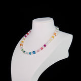 Close-up of a handmade rainbow Swarovski crystal charm necklace with crystals, pearls and rainbow-inspired collectible charm details