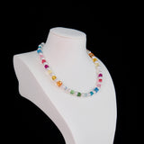 Close-up of a handmade rainbow Swarovski crystal charm necklace with crystals, pearls and rainbow-inspired collectible charm details