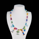 Close-up of a handmade rainbow Swarovski crystal charm necklace with crystals, pearls and rainbow-inspired collectible charm details