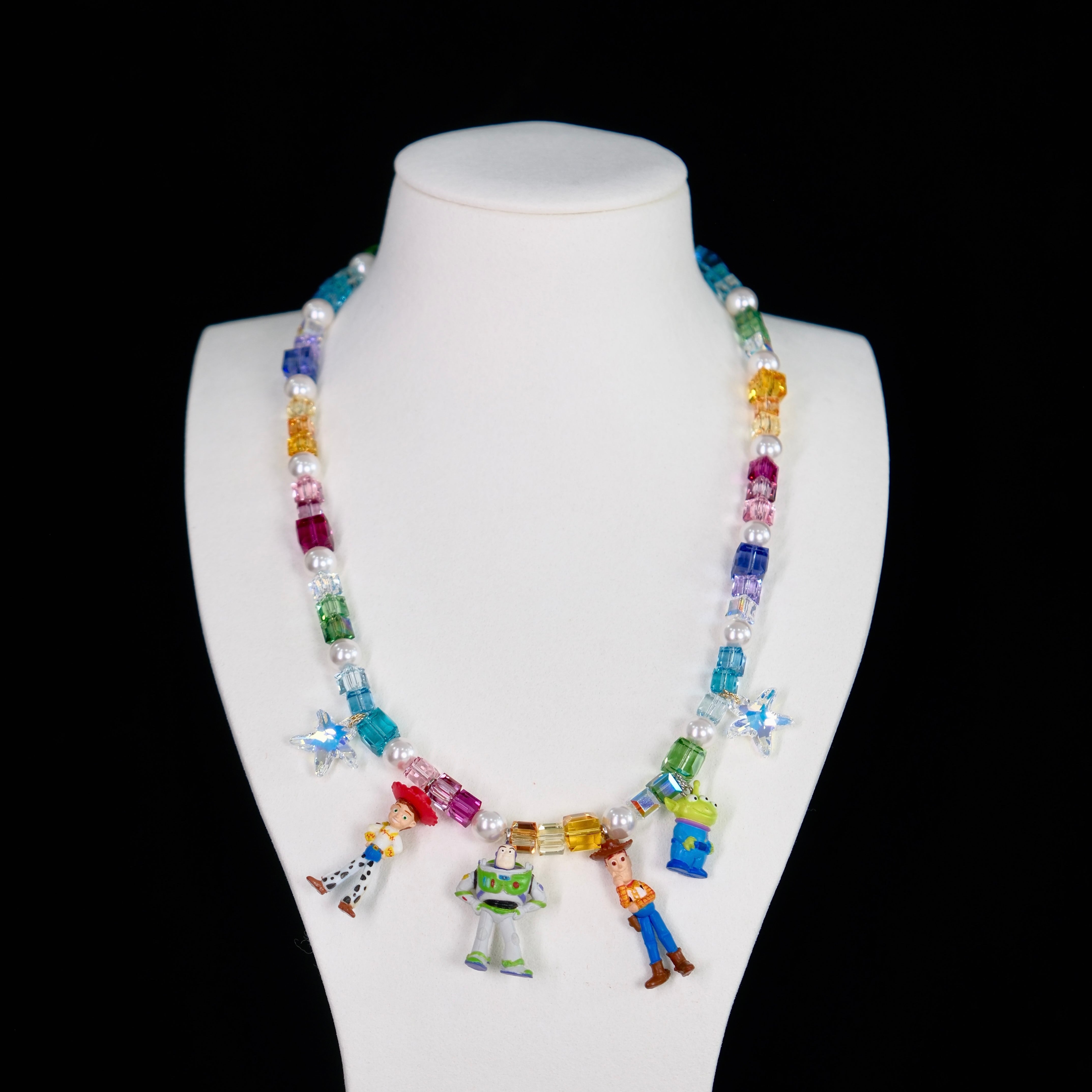 Close-up of a handmade rainbow Swarovski crystal charm necklace with crystals, pearls and rainbow-inspired collectible charm details