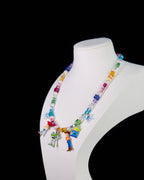Close-up of a handmade rainbow Swarovski crystal charm necklace with crystals, pearls and rainbow-inspired collectible charm details