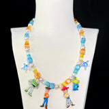 Close-up of a handmade Swarovski crystal charm necklace with crystals, pearls and rainbow-inspired collectible charm details