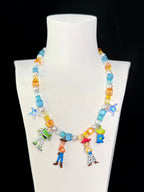 Close-up of a handmade Swarovski crystal charm necklace with crystals, pearls and rainbow-inspired collectible charm details