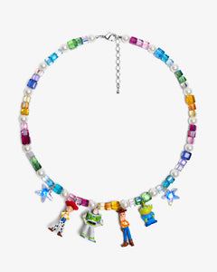 Flat lay of a handmade rainbow Swarovski crystal charm necklace with crystals, pearls and rainbow-inspired collectible charm details