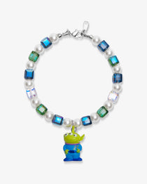 Flat lay of a handmade Swarovski crystal charm bracelet with crystals, pearls and cosmic-inspired collectible charm details