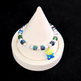 Side view of a handmade Swarovski crystal charm bracelet with layered crystals, pearls and cosmic-inspired collectible charm details