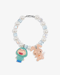 Close-up of a handmade Swarovski crystal charm bracelet with crystals, pearls and retro-inspired collectible charm details