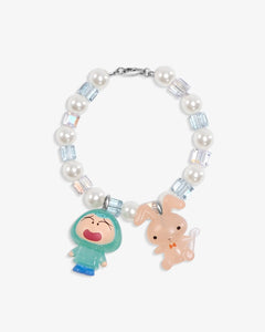 Close-up of a handmade Swarovski crystal charm bracelet with crystals, pearls and retro-inspired collectible charm details