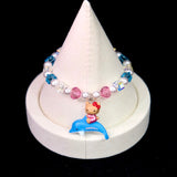 Close-up of a handmade Swarovski crystal charm bracelet with crystals, pearls and surf-inspired collectible charm details