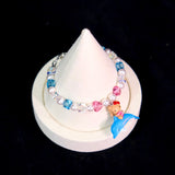Model wearing a handmade Swarovski crystal charm bracelet with crystals, pearls and surf-inspired collectible charm details