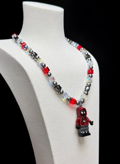 Model wearing a handmade Swarovski crystal charm necklace with crystals, pearls and city-inspired collectible charm details