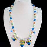 Close-up of a handmade Swarovski crystal charm necklace with crystals, pearls and garden-inspired collectible charm details