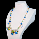 Close-up of a handmade Swarovski crystal charm necklace with crystals, pearls and garden-inspired collectible charm details