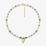 Close-up of a handmade Swarovski crystal charm necklace with crystals, pearls and garden-inspired collectible charm details