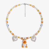 Close-up of a handmade Swarovski crystal charm necklace with crystals, pearls and holiday-inspired collectible charm details