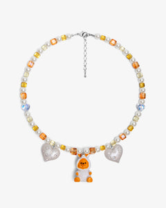 Close-up of a handmade Swarovski crystal charm necklace with crystals, pearls and holiday-inspired collectible charm details