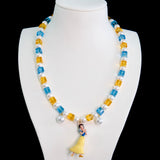 Close-up of a handmade Swarovski crystal charm necklace with crystals, pearls and princess-inspired collectible charm details