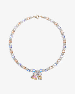 Close-up of a handmade Swarovski crystal charm necklace with crystals, pearls and princess-inspired collectible charm details