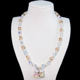Close-up of a handmade Swarovski crystal charm necklace with crystals, pearls and princess-inspired collectible charm details