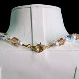 Close-up of a handmade Swarovski crystal charm necklace with crystals, pearls and princess-inspired collectible charm details