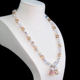 Model wearing a handmade Swarovski crystal charm necklace with crystals, pearls and princess-inspired collectible charm details