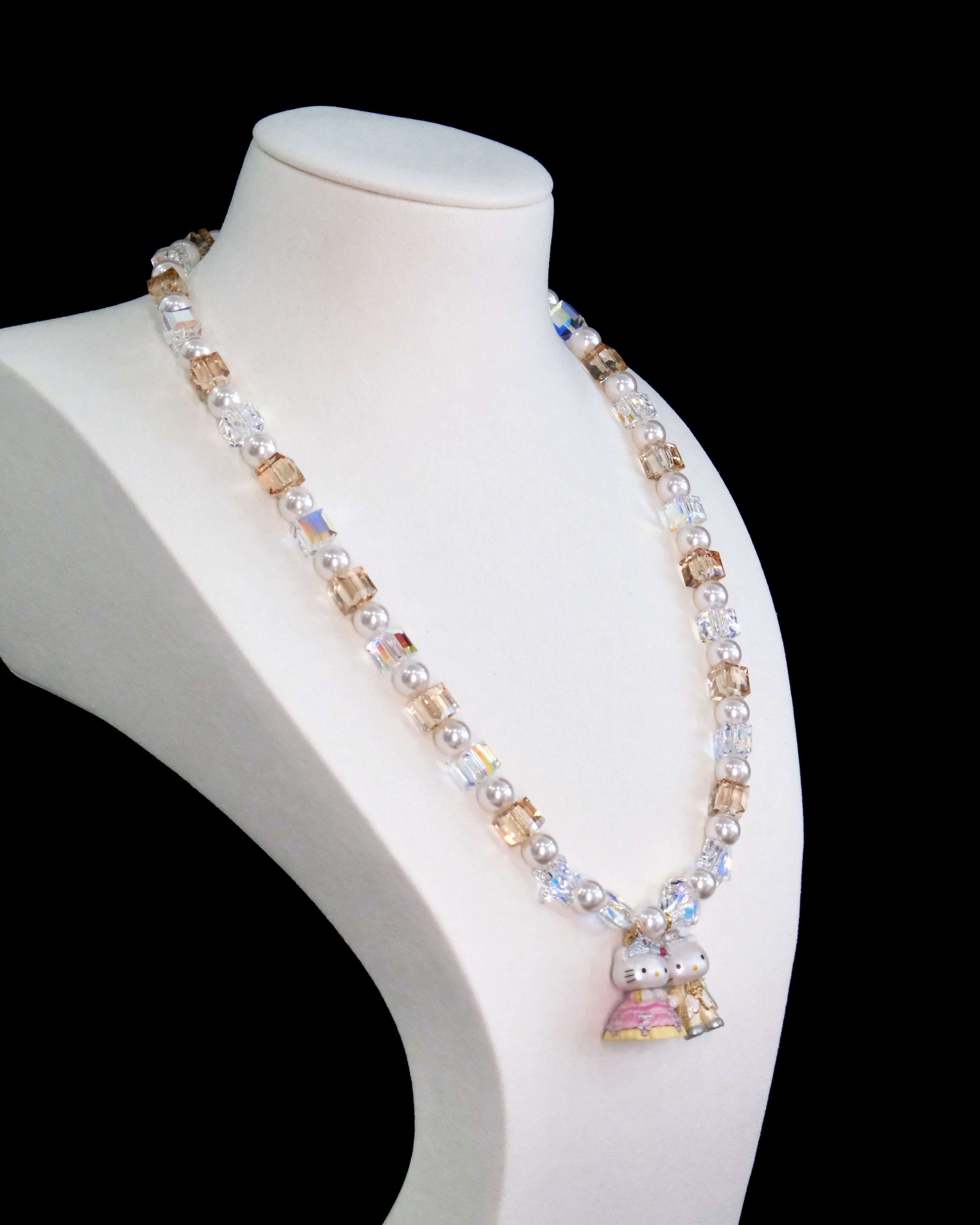 Model wearing a handmade Swarovski crystal charm necklace with crystals, pearls and princess-inspired collectible charm details