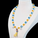 Model wearing a handmade Swarovski crystal charm necklace with crystals, pearls and princess-inspired collectible charm details