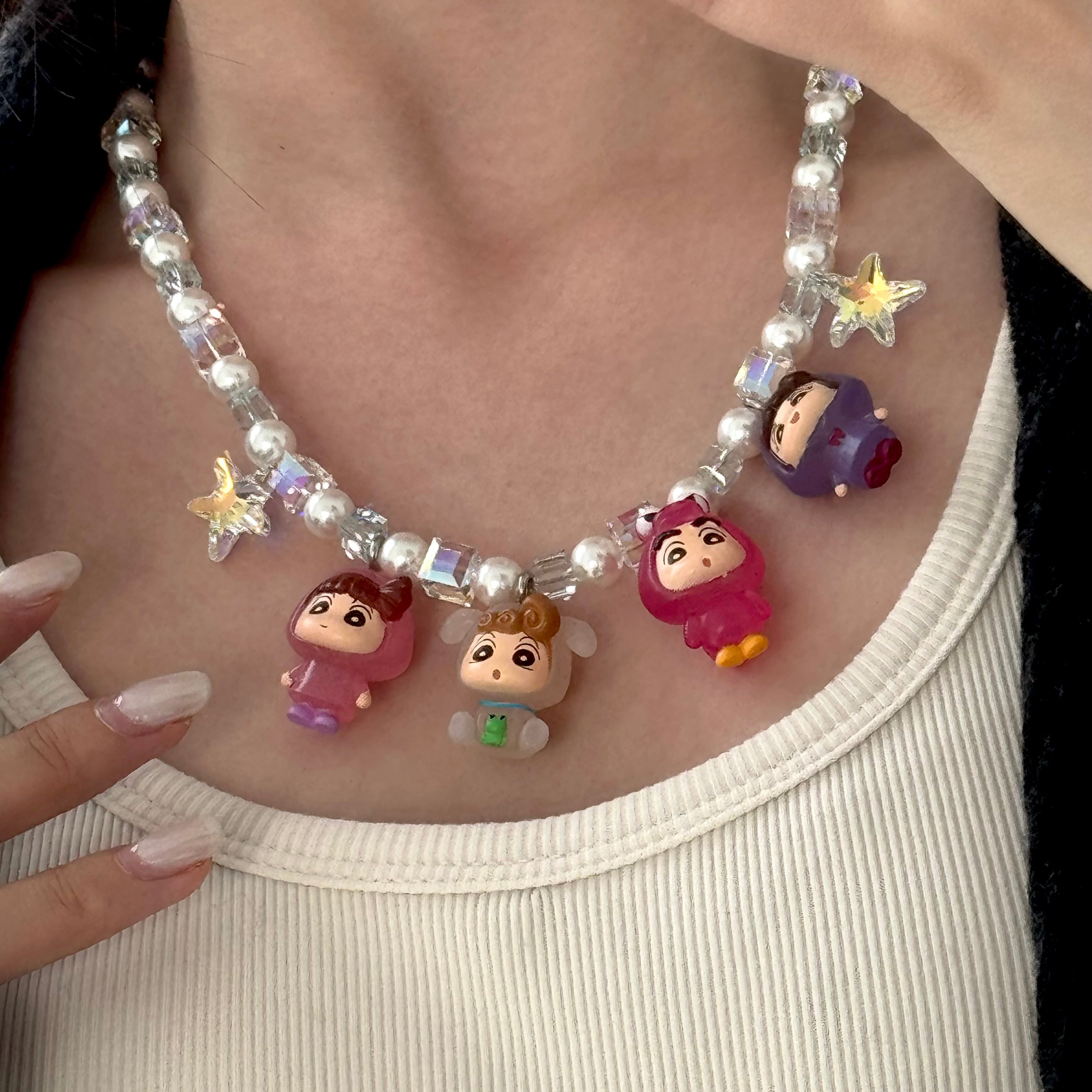 Close-up of a handmade Swarovski crystal charm necklace with crystals, pearls and retro-inspired collectible charm details