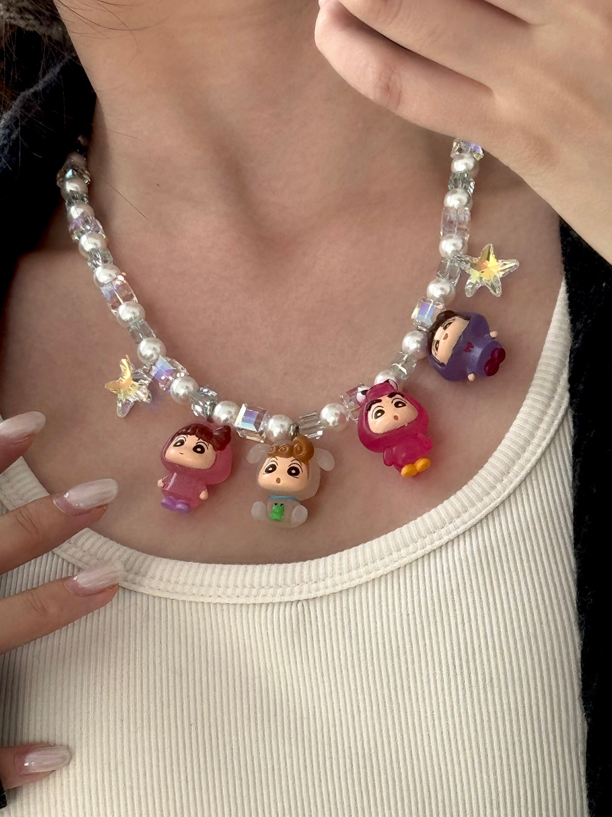 Close-up of a handmade Swarovski crystal charm necklace with crystals, pearls and retro-inspired collectible charm details