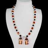 Close-up of a handmade Swarovski crystal charm necklace with crystals, pearls and retro-inspired collectible charm details