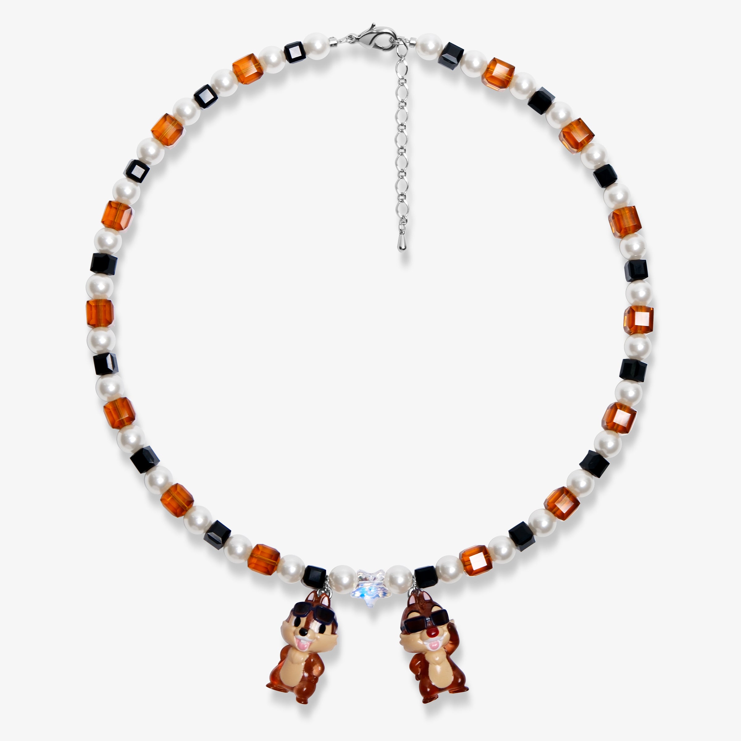 Flat lay of a handmade Swarovski crystal charm necklace with crystals, pearls and retro-inspired collectible charm details
