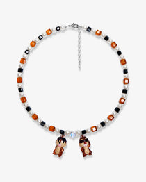 Flat lay of a handmade Swarovski crystal charm necklace with crystals, pearls and retro-inspired collectible charm details