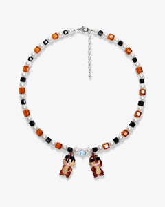 Flat lay of a handmade Swarovski crystal charm necklace with crystals, pearls and retro-inspired collectible charm details