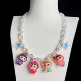 Model wearing a handmade Swarovski crystal charm necklace with crystals, pearls and retro-inspired collectible charm details