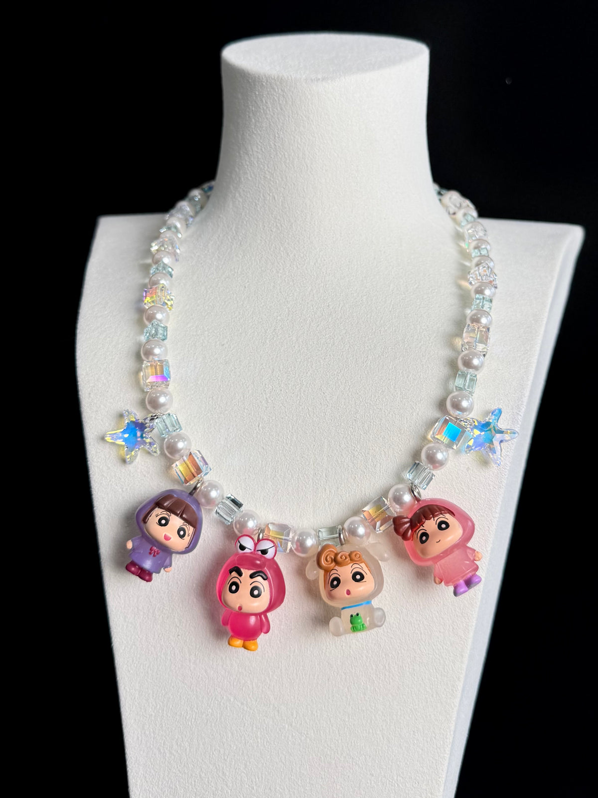 Model wearing a handmade Swarovski crystal charm necklace with crystals, pearls and retro-inspired collectible charm details