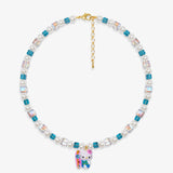 Close-up of a handmade Swarovski crystal charm necklace with crystals, pearls and surf-inspired collectible charm details