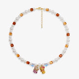 Close-up of a handmade Swarovski crystal charm necklace with crystals, pearls and surf-inspired collectible charm details