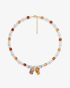 Close-up of a handmade Swarovski crystal charm necklace with crystals, pearls and surf-inspired collectible charm details