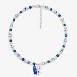 Close-up of a handmade Swarovski crystal charm necklace with crystals, pearls and surf-inspired collectible charm details