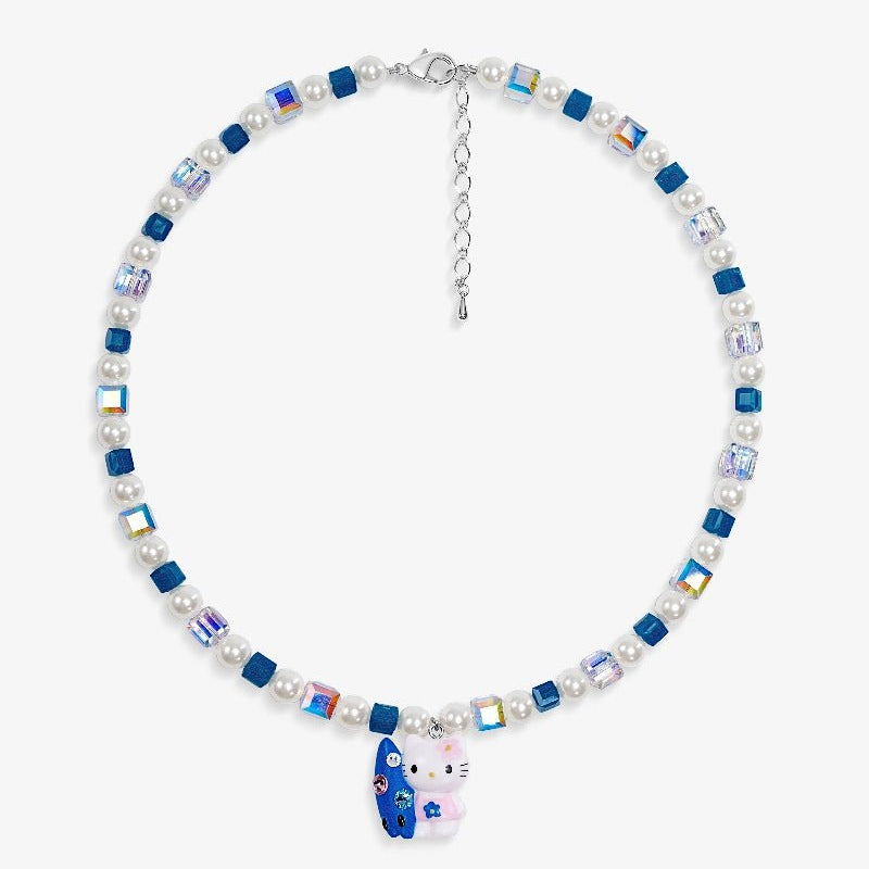 Close-up of a handmade Swarovski crystal charm necklace with crystals, pearls and surf-inspired collectible charm details