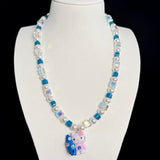 Model wearing a handmade Swarovski crystal charm necklace with crystals, pearls and surf-inspired collectible charm details