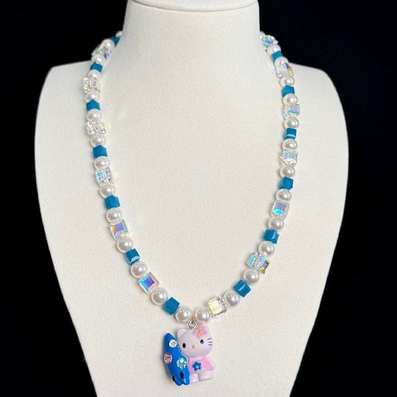 Model wearing a handmade Swarovski crystal charm necklace with crystals, pearls and surf-inspired collectible charm details