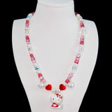 Close-up of a handmade Swarovski crystal charm necklace with crystals, pearls and sweetheart-inspired collectible charm details